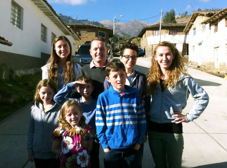 Haley McNeese (top left) poses with fellow WorldWide Witness intern Natali Schroeder and the Caire family in the summer of 2015 while the Caires were living in Peru.  
