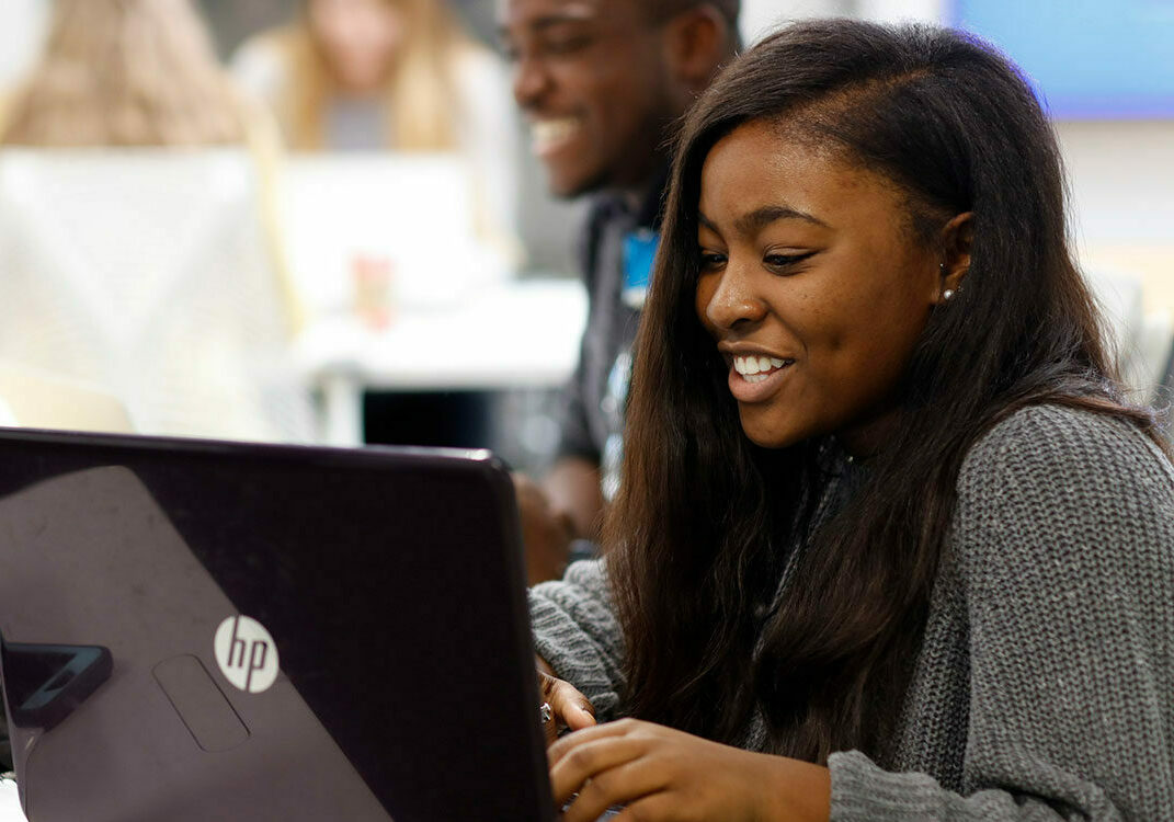 an ACU online program student attending class on her laptop