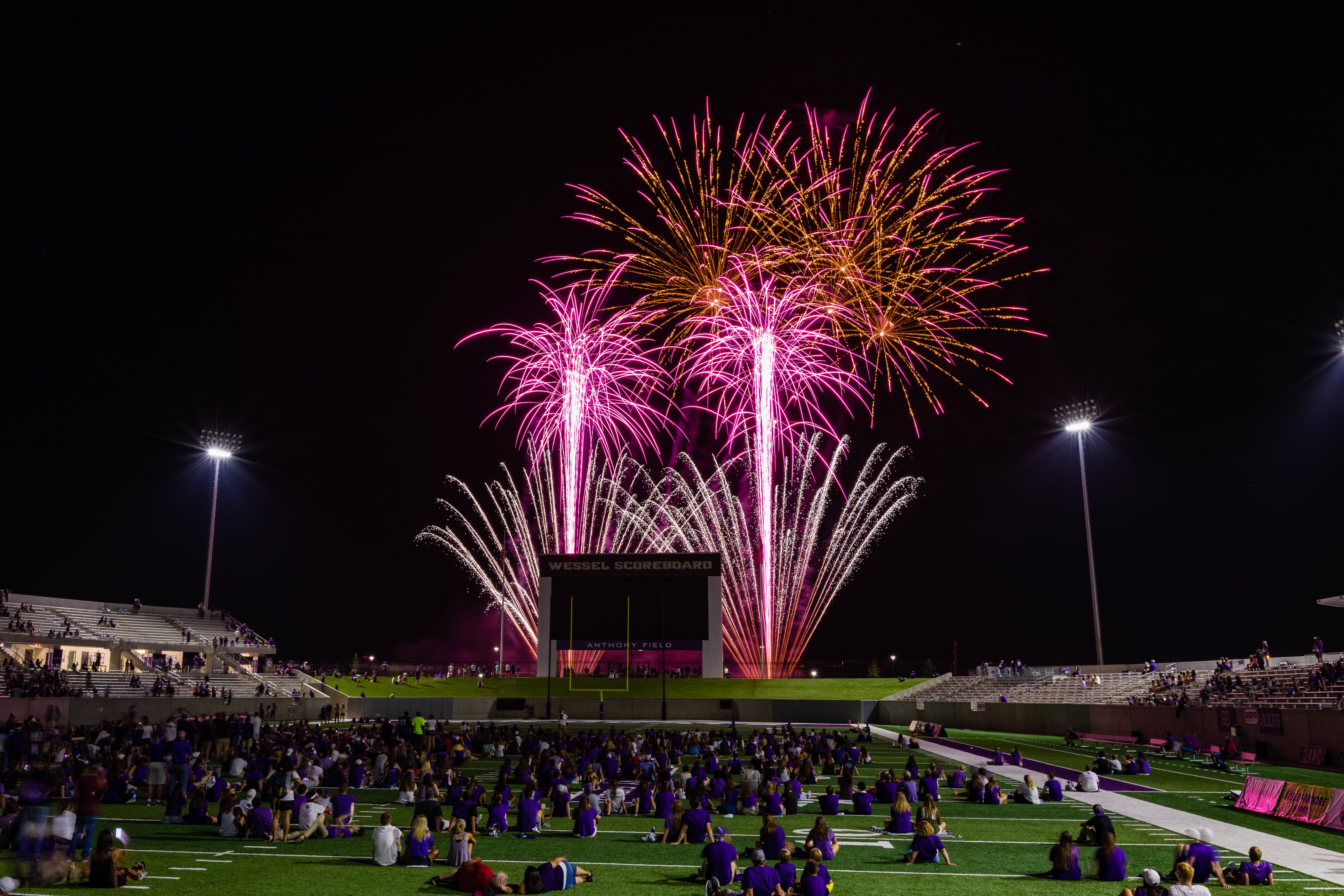 A brilliant display of fireworks illuminates the stadium.