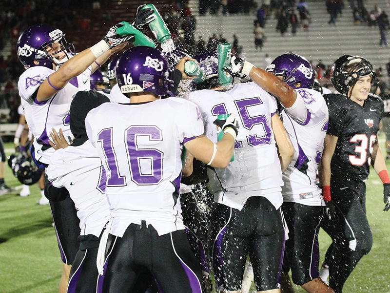 Teammates douse Mitchell Gale (15) after he became the ACU and LSC career passing leader following the 2012 game with Incarnate Word.