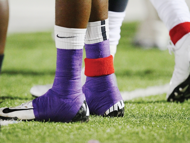 Each ACU player wore a red sweatband around an ankle during the 2012 game with Incarnate Word.