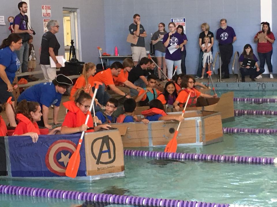 Middle school students race boats they constructed from cardboard, duct tape and glue with the guidance of ACU engineering and physics students.