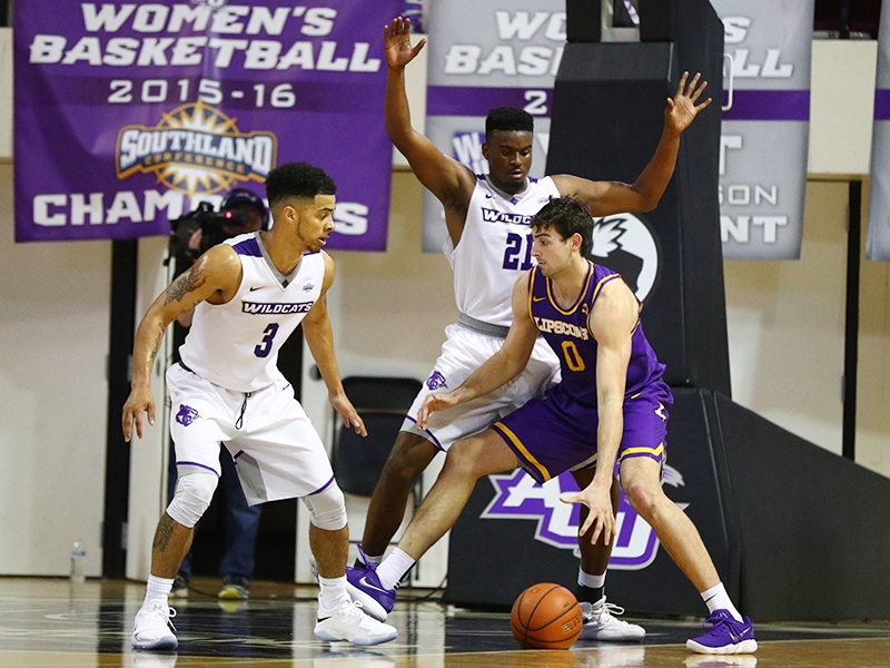 ACU guard Tevin Foster (3) and center Jalone Friday (21) guard Lipscomb forward Rob Marberry (0)