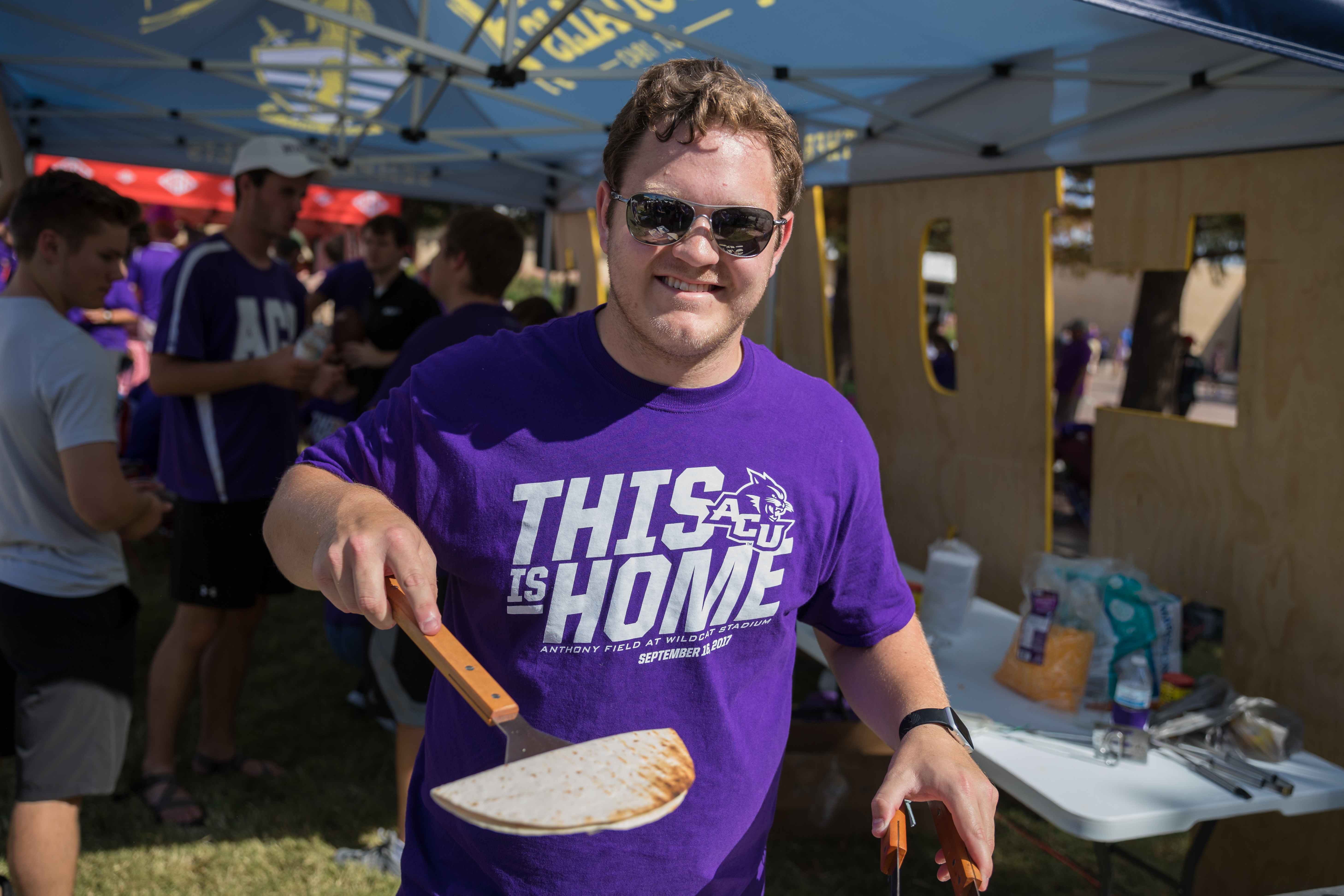 Kory Murdock of Frater Sodalis serves up a quesadilla, the club's signature tailgating food.