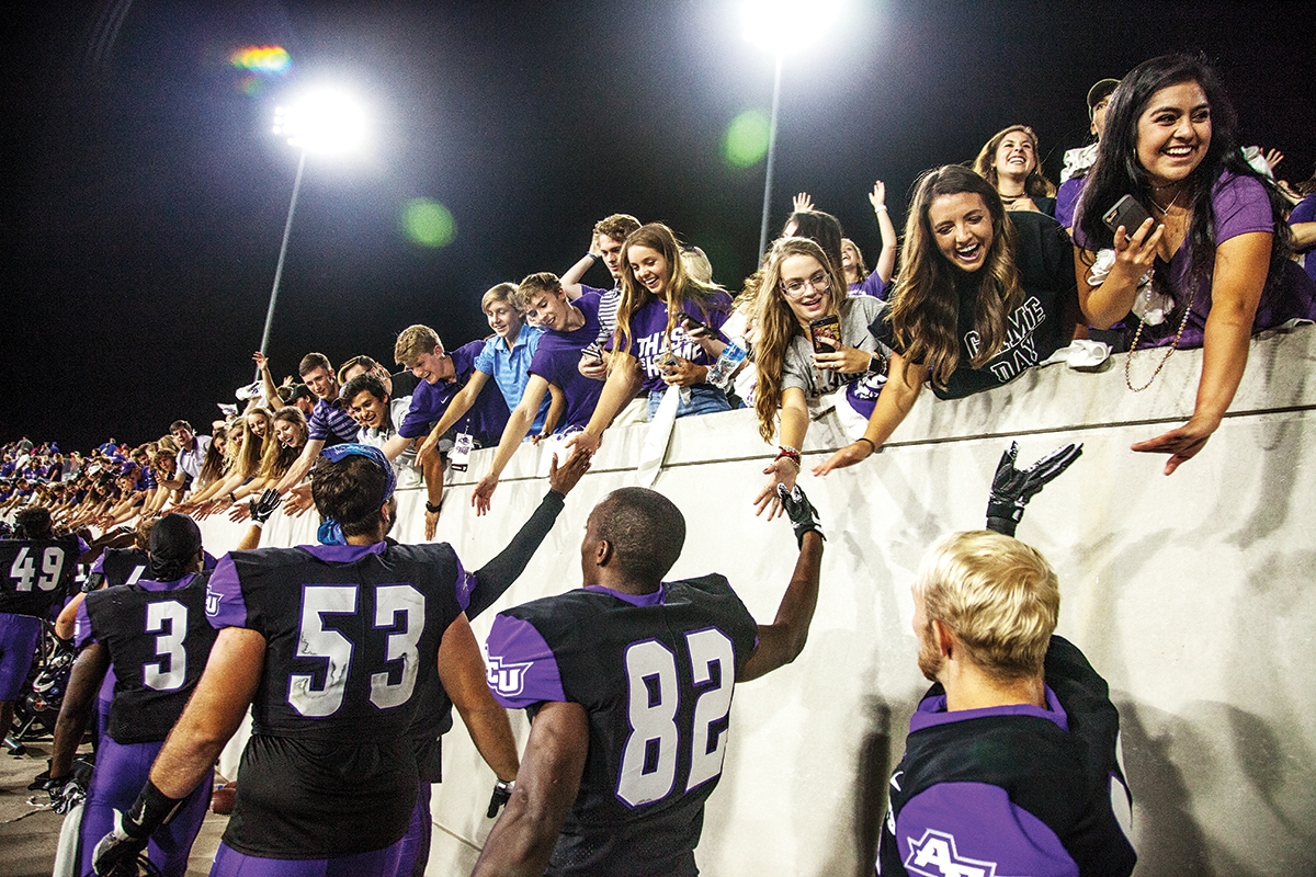 Fans line the Anthony Field walls at Wildcat Stadium to congratulate players after their Grand Opening win last fall over Houston Baptist University