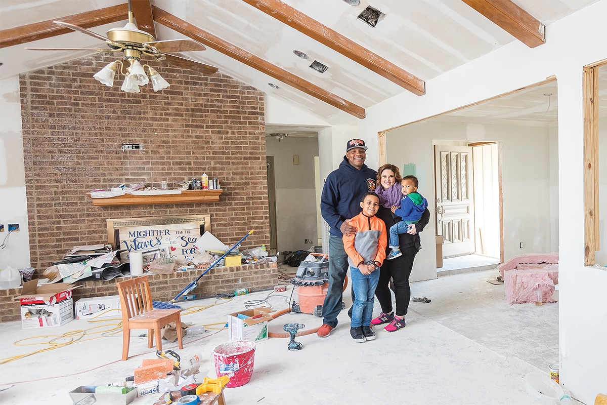 While firefighter Azzie Beagnyam (above, left) helped respond to the needs of people in Pearland, Texas, the house in Dickinson he and his wife, Ashlee, owned was severely damaged by flooding. The Beagnyams, including sons Lincoln and Boston, pose in January 2018 among the ongoing renovations as they put their home back together. They moved back in late March.