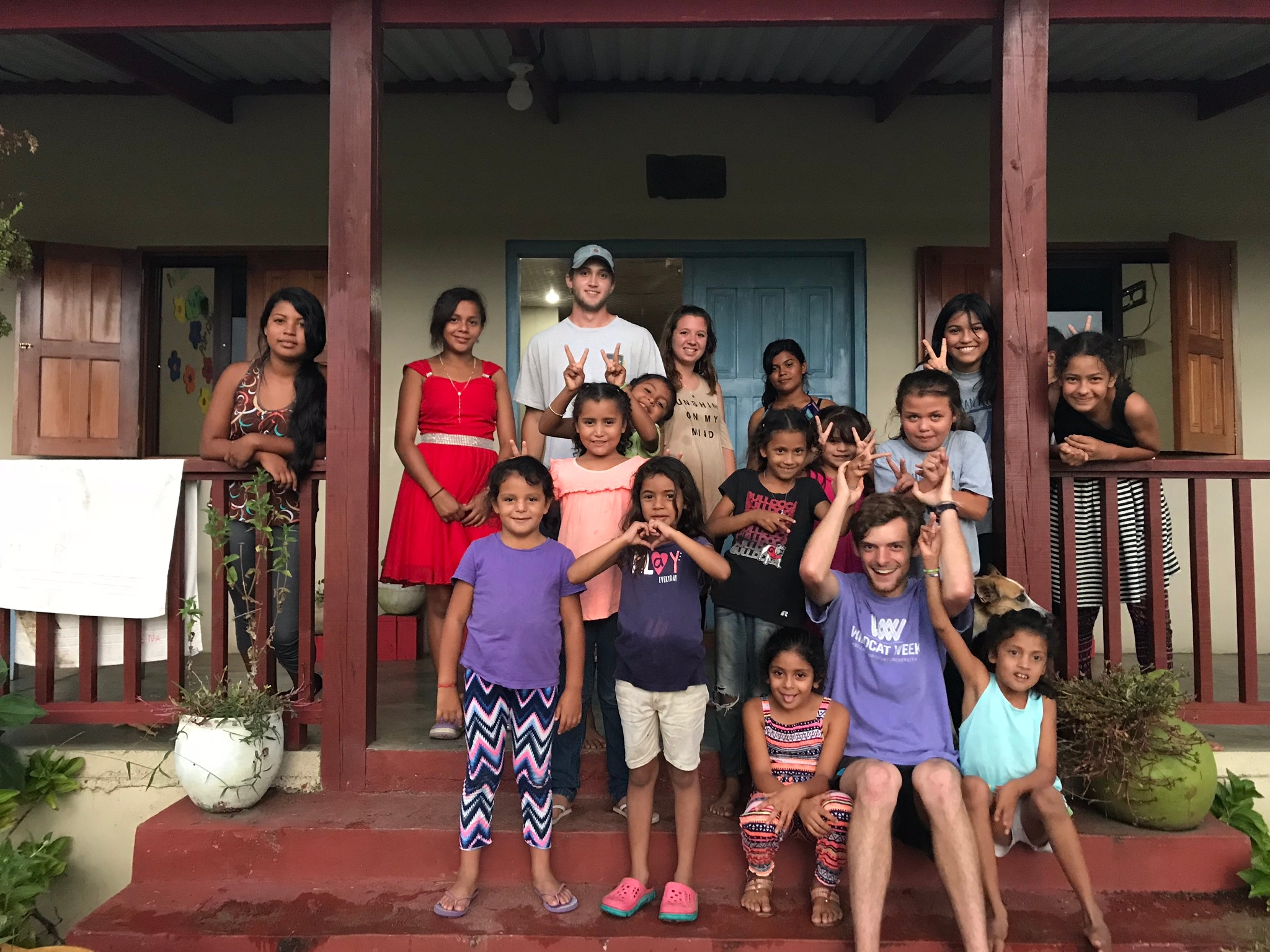 Engineering and physics students on children's home porch in Honduras
