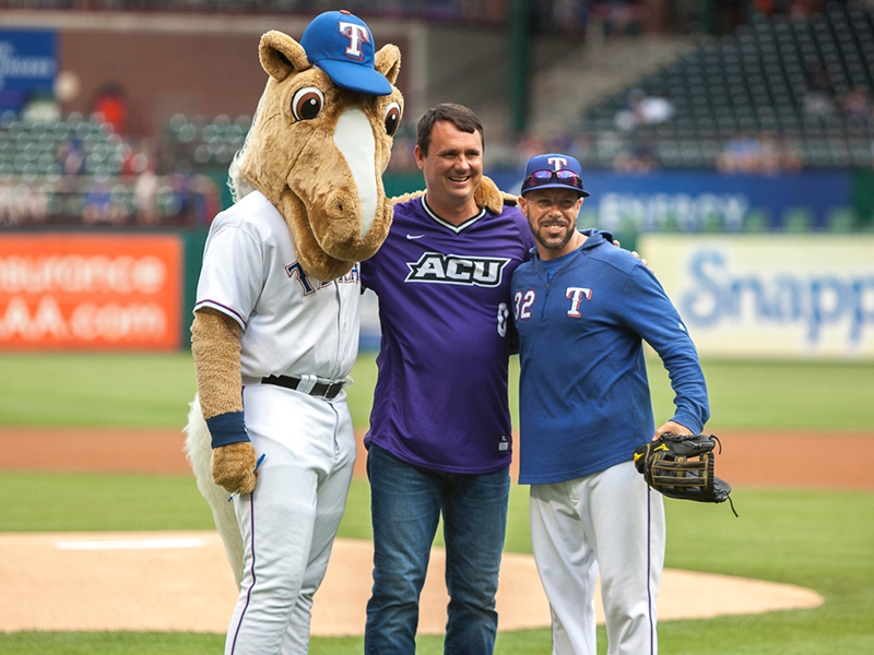 Rangers’ mascot Captain and assistant coach Jayce Tingler pose with Golding after his ceremonial first pitch.
