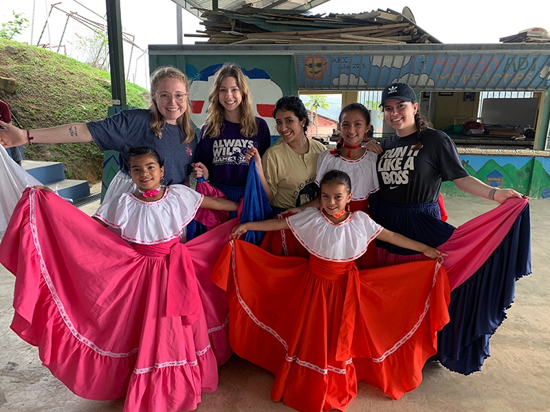 ACU students (from left) Madeline Dayton, Katey Loveless, Mafer Hernandez and Alison Zuniga are shown local dances by children in the village of Mollejones. The students were part of a Study Abroad course offered by the College of Business Administration.