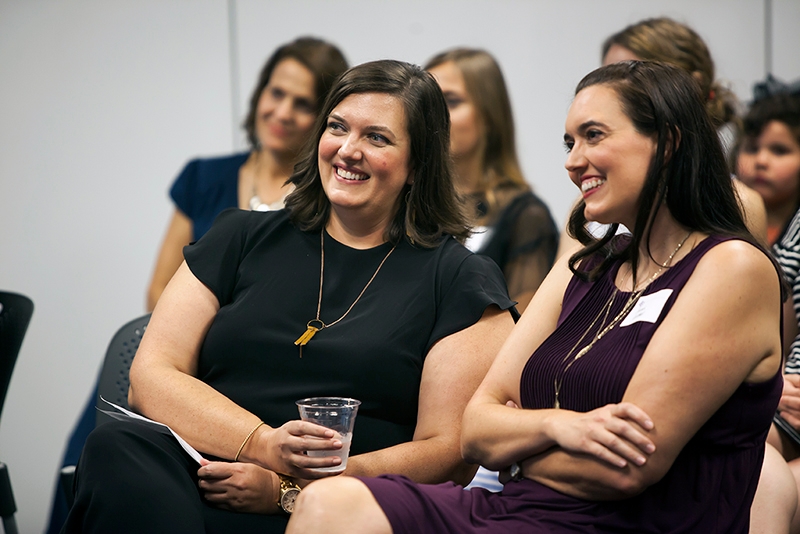 Katie Coldwell ('00), left, and her sister, Sarah Coldwell, listen as Katie is honored with a 2019 Distinguished Alumni Citation.