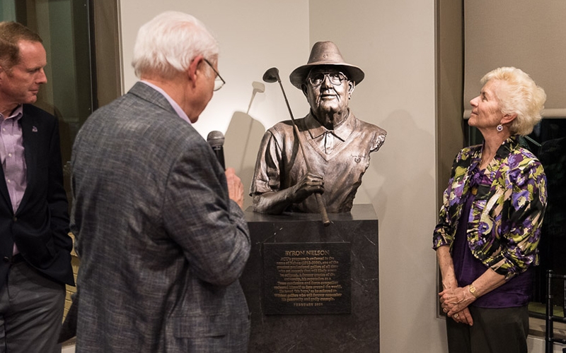 Head golf coach Tom Shaw, Jon Bradley (’72) and Peggy Nelson Jaros admire the bronze sculpture of Byron Nelson.