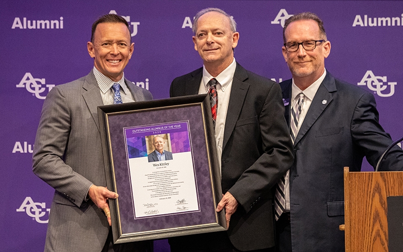 Dr. Phil Schubert (’91), president (right), and Craig Fisher ('92), assistant vice president of alumni and university relations (left), present Wes Kittley (’81), with his 2020 Outstanding Alumnus of the Year Award at the Alumni Day Luncheon on Feb. 23. 