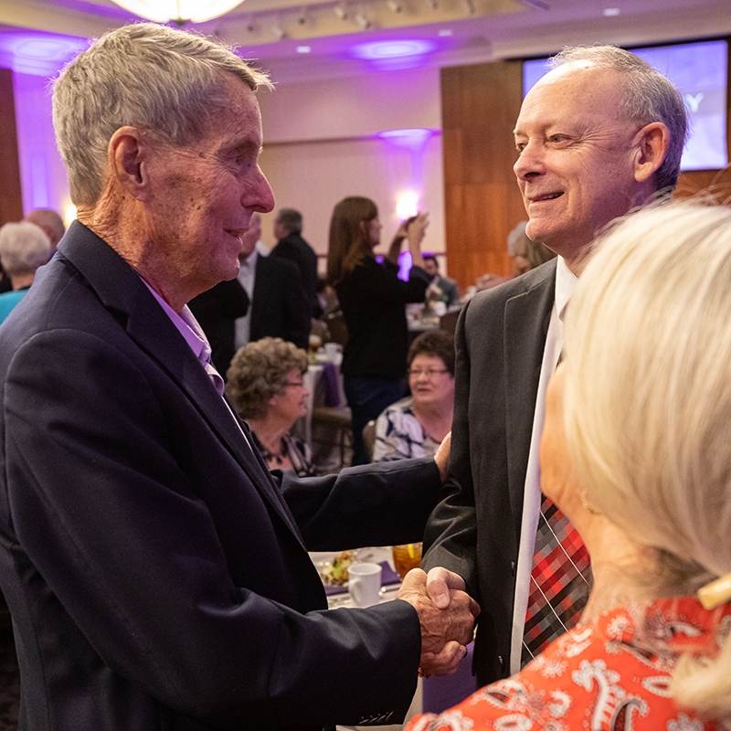 A. Don Drennan (’58) greets Wes Kittley (’81), ACU's 2020 Outstanding Alumnus of the Year, at the Alumni Day luncheon Feb. 23.