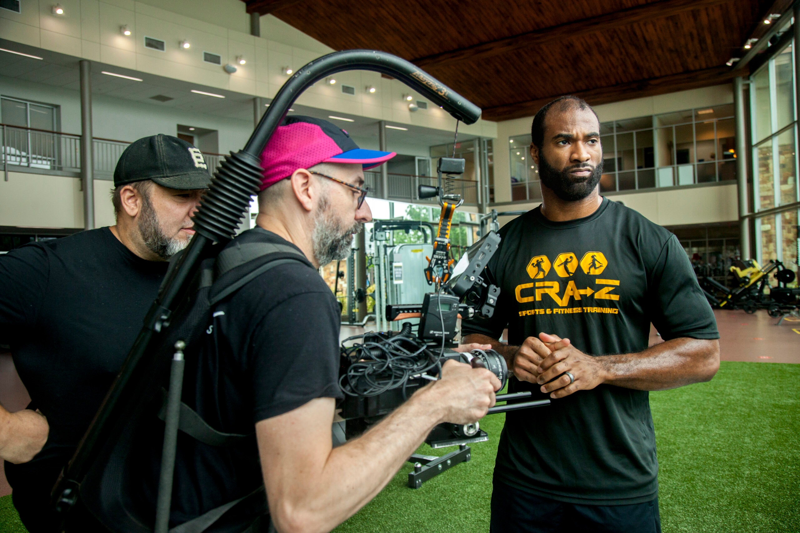 Zaviar Gooden (right), an online MBA student who played five seasons in the NFL, prepares to talk about his experience at ACU for a TV commercial.