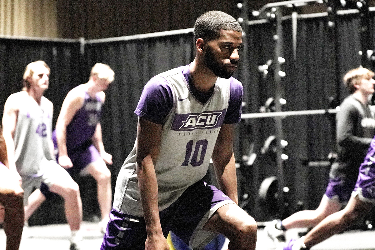 Senior guard Reggie Miller and his ACU teammates stretch before a workout session in Indianapolis.